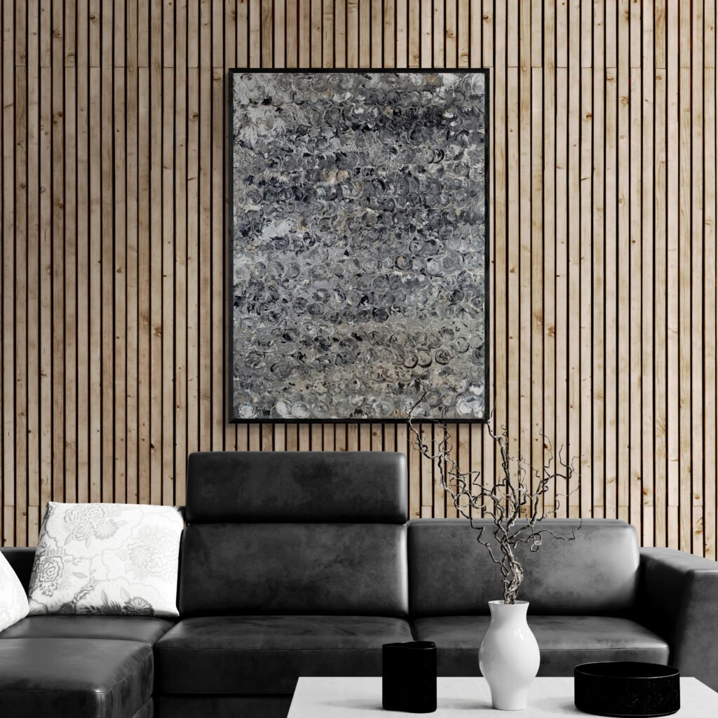 Argent abstract canvas adding a modern touch to a living room with a stylish leather sofa and wooden accent wall