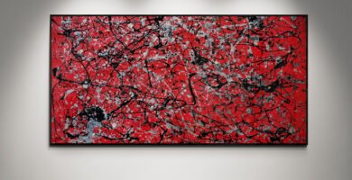 Number 12 Jackson Pollock-style red abstract canvas displayed in a modern gallery setting with bright spotlights and a wooden floor