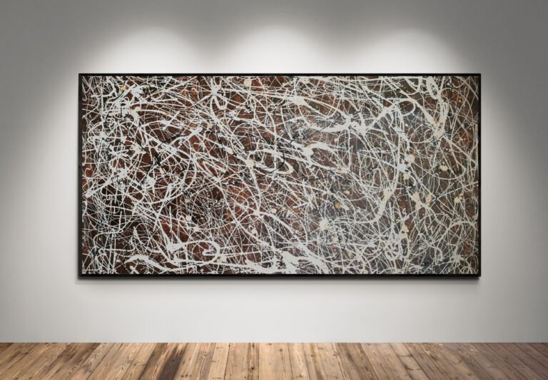 Number 15 – Jackson Pollock Style Brown Abstract Canvas displayed under spotlights, highlighting its elegant white, sand, and black splashes over a brown background