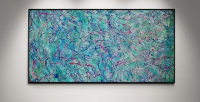 Jackson Pollock-style abstract artwork with tropical hues displayed in a modern gallery setting under soft spotlights