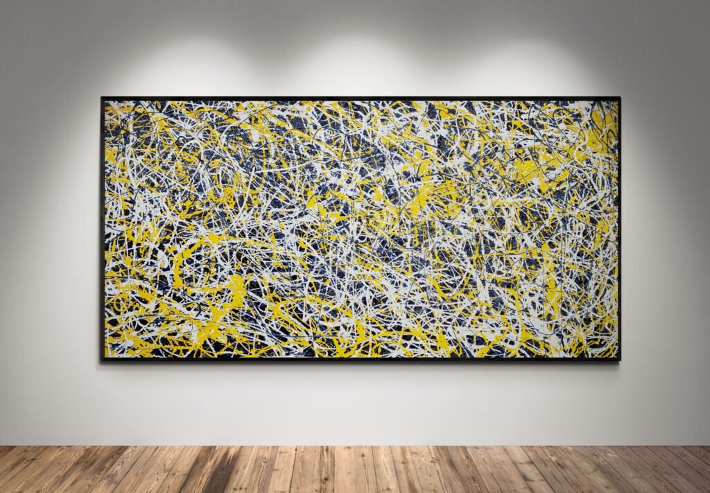 Framed abstract yellow and white Jackson Pollock-style painting displayed on a gallery wall under spotlights, showcasing vibrant energy