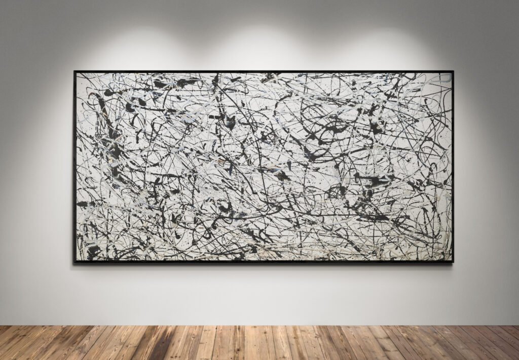 Number 7, a monochrome Jackson Pollock Style abstract canvas, showcasing bold black, gray, and silver splashes on a white background, displayed in a minimalist gallery setting