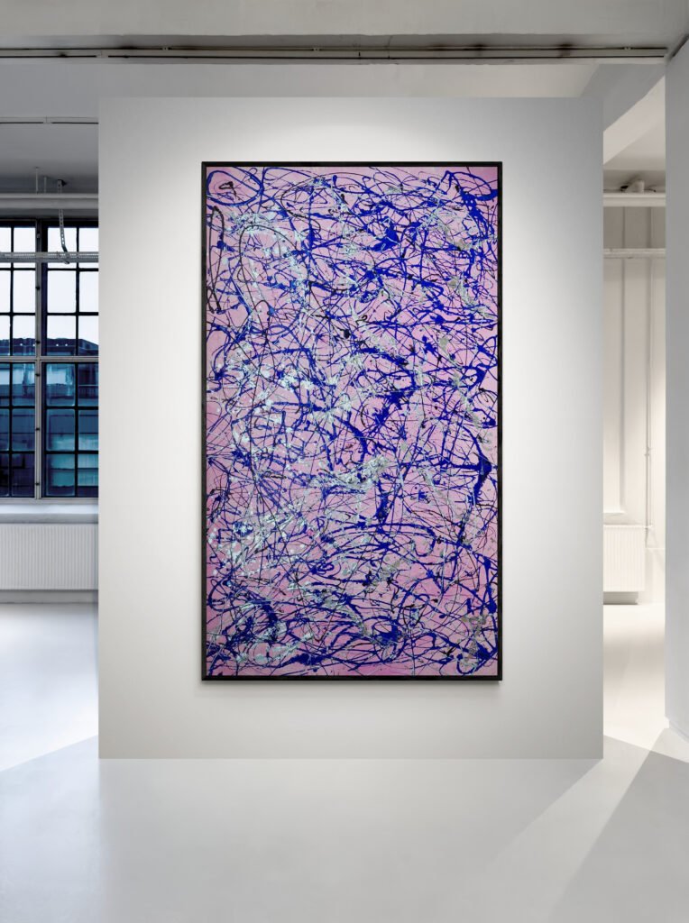 Jackson Pollock Style Pink Abstract Canvas presented in a minimalist gallery space, emphasizing its bold pink and blue strokes against a white wall