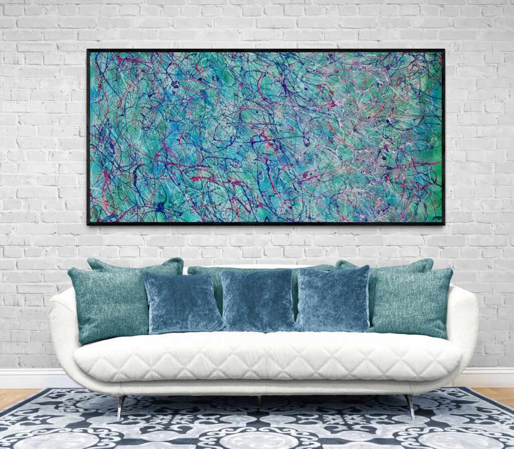 Framed Jackson Pollock-style artwork in tropical shades, complementing a luxurious white sofa with textured pillows in a stylish living room