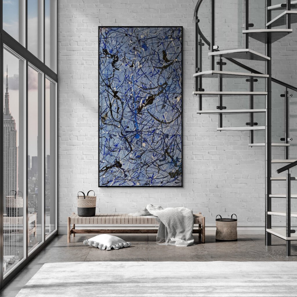 Number 14 – Blue abstract Jackson Pollock-style canvas in an industrial-style living room with a spiral staircase and large windows