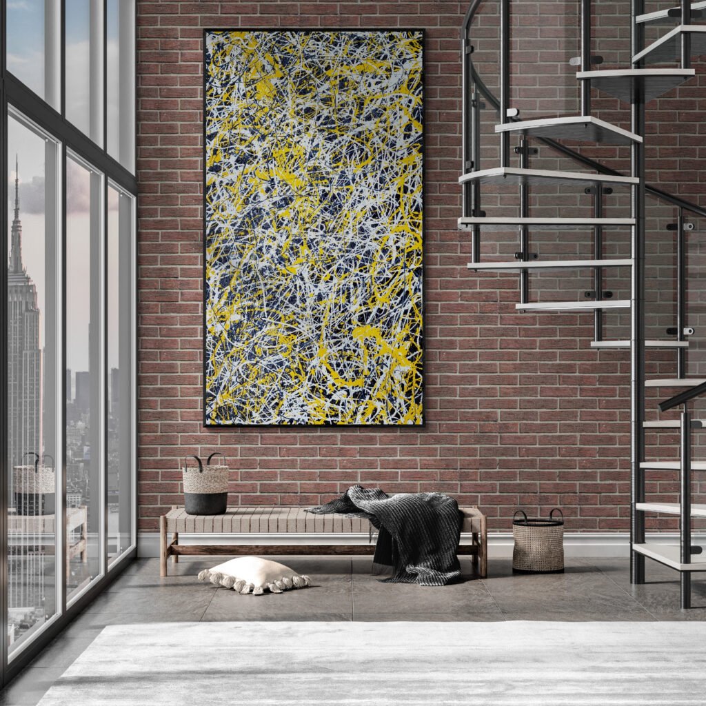 Large abstract painting in yellow and white tones hanging on an industrial-style brick wall next to a spiral staircase with a cozy bench below