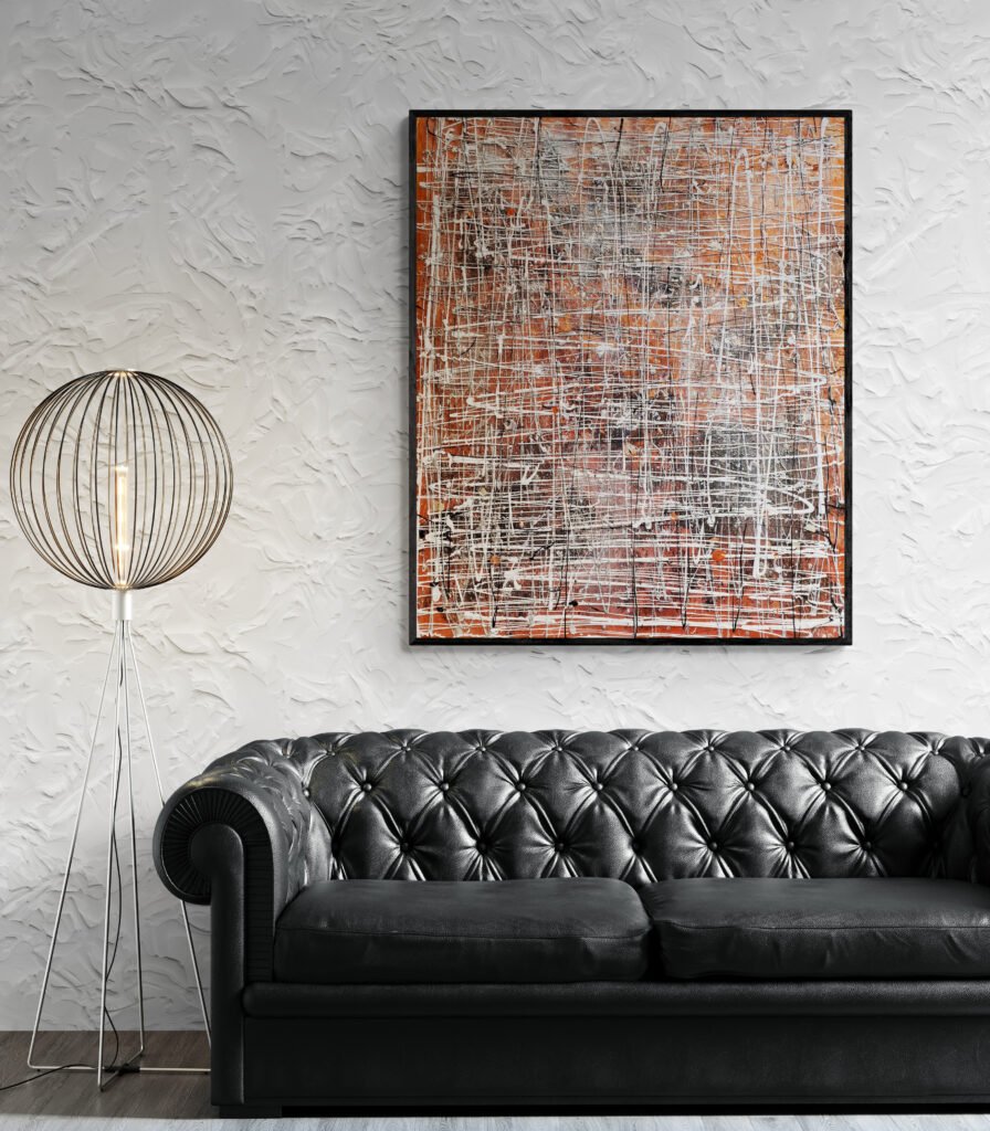 A textured wall accentuates the Winterk masterpiece, with a black leather Chesterfield sofa and a metallic modern lamp complementing the scene