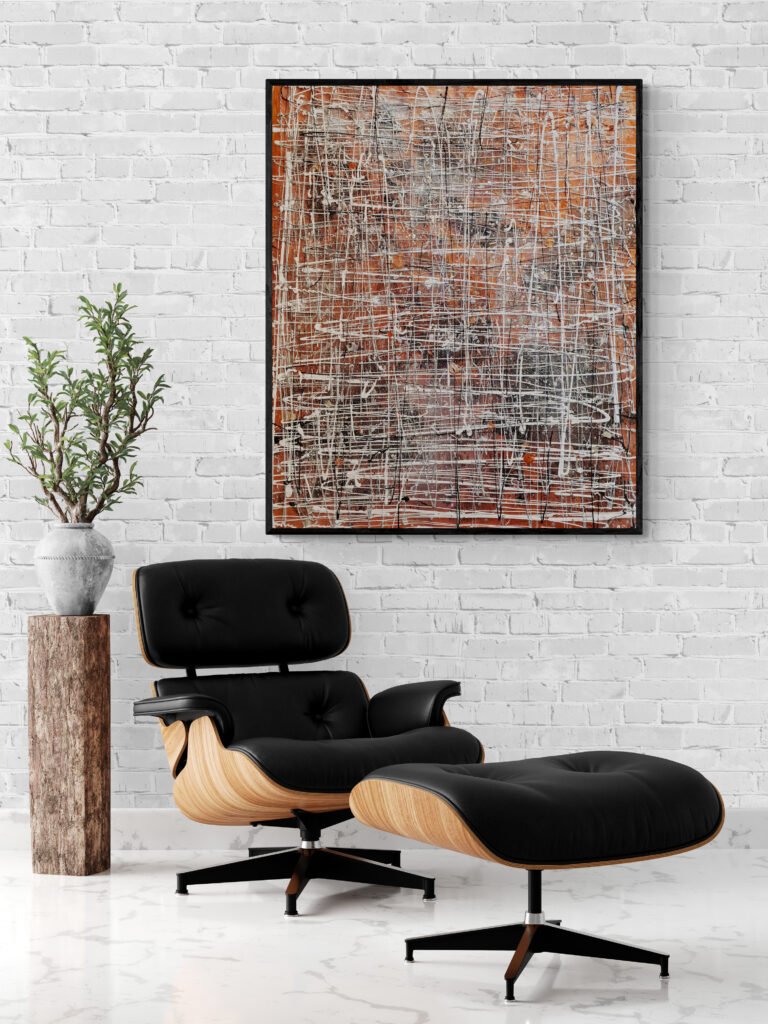 A bright room with white brick walls, featuring the Winterk painting above a black leather and wood lounge chair