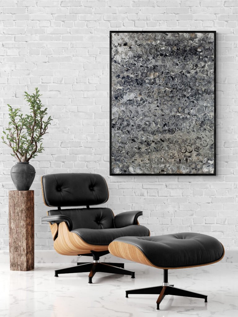 Argent abstract canvas decorating a room with a sophisticated black chair and matching footstool, blending style and comfort