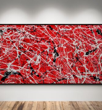 Large red drip painting with black, white, and silver splashes showcased under gallery lighting on a clean wall.