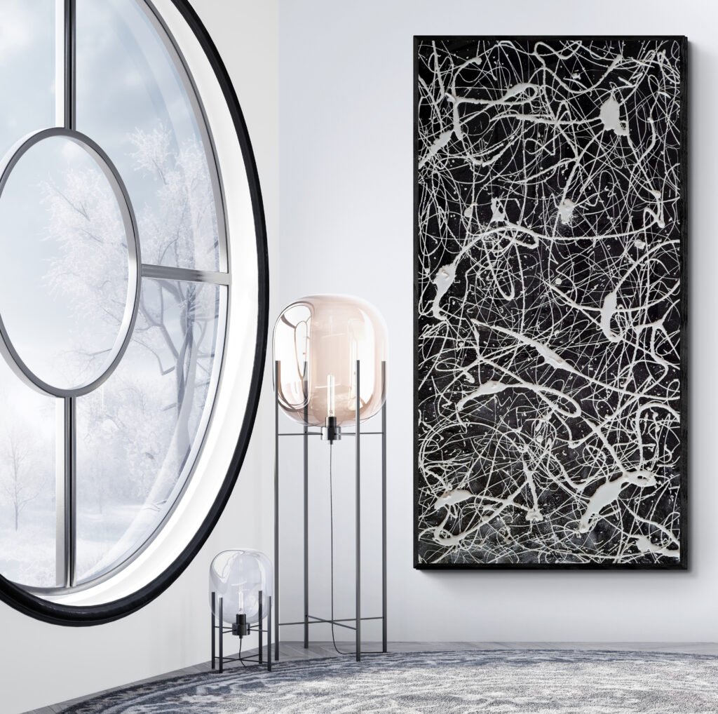"Number 77" black and white canvas artwork near designer lamps and round window with winter scenery outside