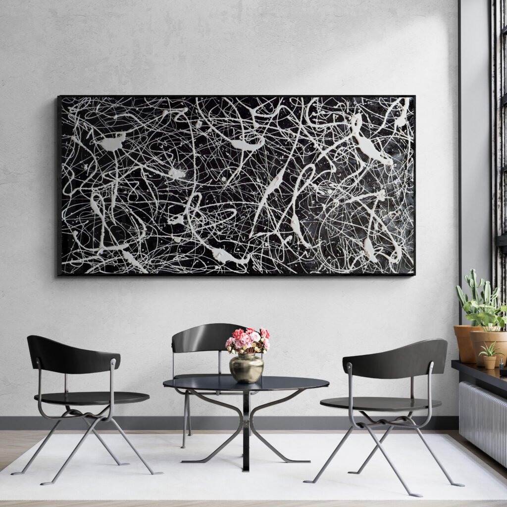 Modern seating area with "Number 77" black and white abstract canvas, Jackson Pollock style artwork on grey wall