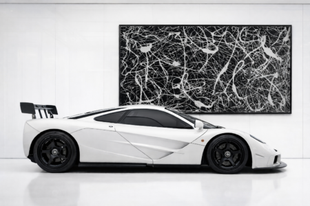 extra large pollock inspired black and white abstract wall art behind luxury sports car modern gallery