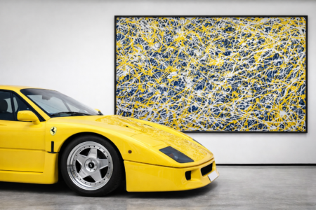 large Jackson Pollock style yellow and black abstract painting in modern gallery with sports car