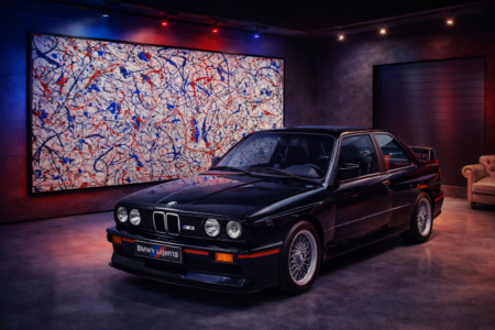 large red and blue Jackson Pollock style abstract wall art with splatter effect in modern car showroom interior