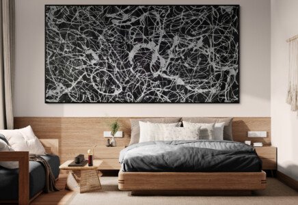 black and silver Jackson Pollock style abstract painting above bed in modern bedroom